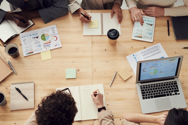 people with marketing materials around a table