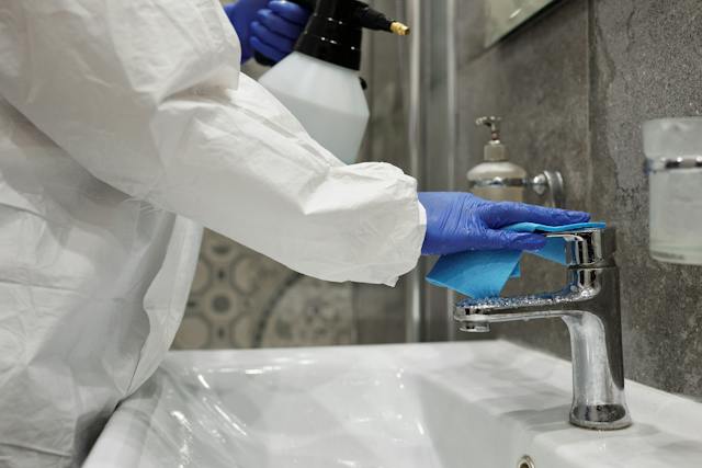 a-person-cleaning-a-faucet