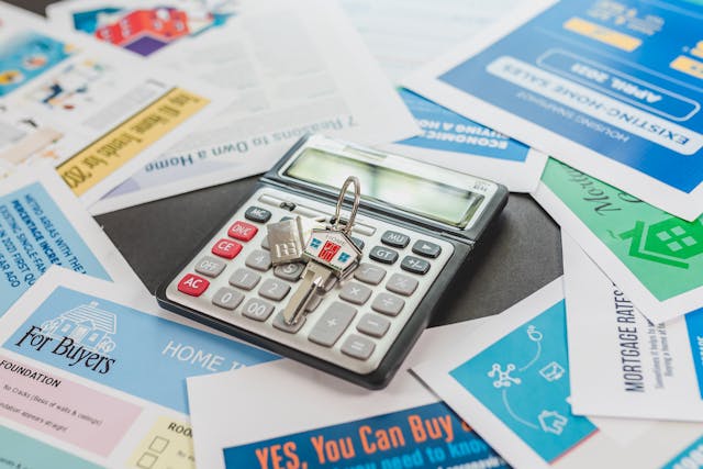 calculator and home keys on top of property owner fliers